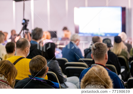 Audience listens to the lecturer at conference hall 77198639