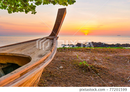 Wooden boat on sunset beach Wooden boat on sunset beach 77201599