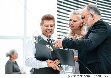 close up. the working group discussing business document close up. the working group discussing business document 77201977