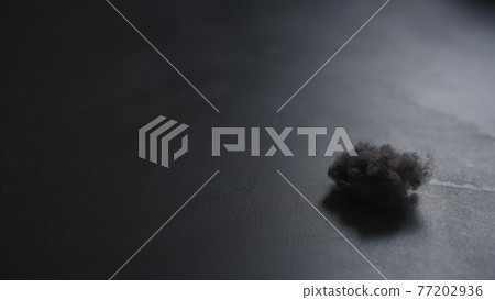 closeup shot of dust ball on concrete floor 77202936