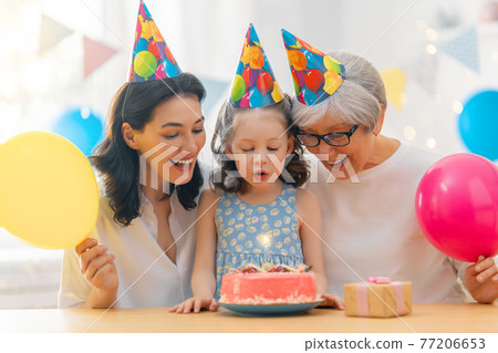 Grandmother, mother and daughter are celebrating birthday. Grandmother, mother and daughter are celebrating birthday. 77206653