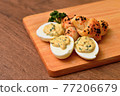 Eggs mimosa cheese mini-croissant on a wooden board. 77206679