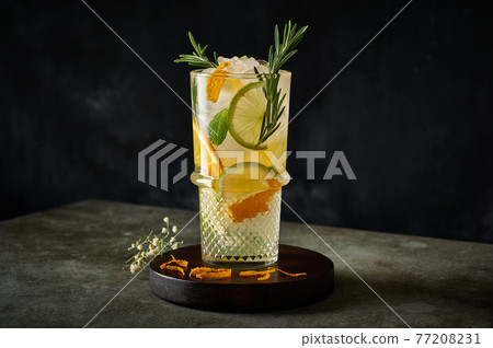 Homemade refreshing summer lemonade cocktail with orange juice, crushed ice and citrus fruits 77208231