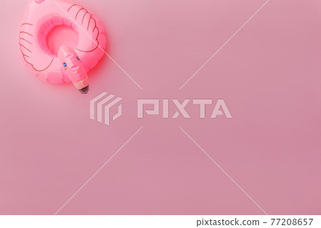 Summer beach composition. Simply minimal design with Inflatable flamingo isolated on pastel pink background. Pool float party, trendy celebrity fashion concept. Flat lay top view copy space. Summer beach composition. Simply minimal design with Inflatable flamingo isolated on pastel pink background. Pool float party, trendy celebrity fashion concept. Flat lay top view copy space. 77208657