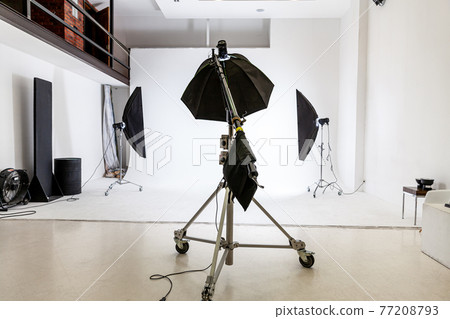 Empty photo studio with lighting equipment. Photographer workplace interior with professional tool set gear. Flash light white background scenes ready for studio shooting. Modern photographer studio Empty photo studio with lighting equipment. Photographer workplace interior with professional tool set gear. Flash light white background scenes ready for studio shooting. Modern photographer studio 77208793