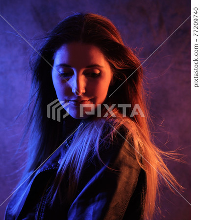 Strong colorful portrait shot of a young woman Strong colorful portrait shot of a young woman 77209740