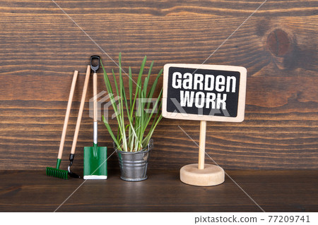 Garden Work. Spring, seasons and hobby concept. Chalk board on a wooden table Garden Work. Spring, seasons and hobby concept. Chalk board on a wooden table 77209741