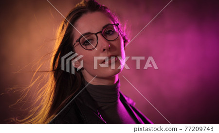 Strong colorful portrait shot of a young woman Strong colorful portrait shot of a young woman 77209743