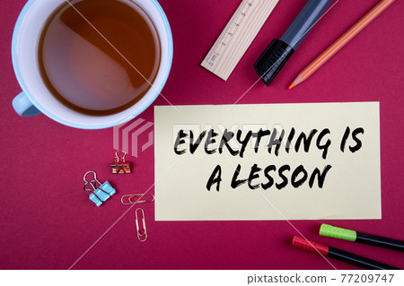 Everything is a lesson. Business, education and experience concept. Office supplies on a red Everything is a lesson. Business, education and experience concept. Office supplies on a red 77209747