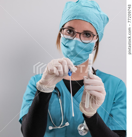 Young doctor has a PCR test in her hands Young doctor has a PCR test in her hands 77209748