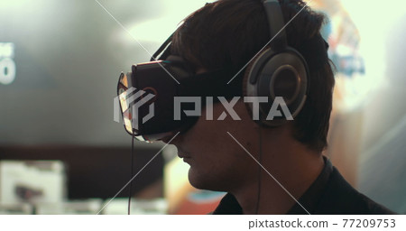 Man using augmented reality device for mobiles 77209753