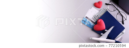 Romantic Airplane Travel planing banner with objects, documents, dollars, passports, boarding pass tickets, glasses, smartphone, and space for text. Romantic Airplane Travel planing banner with objects, documents, dollars, passports, boarding pass tickets, glasses, smartphone, and space for text. 77210594