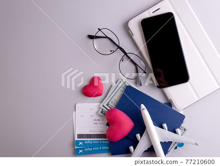 Romantic Airplane Travel preparation Concept objects, documents, dollars, passports, boarding pass tickets, glasses, smartphone, and space for text. Romantic Airplane Travel preparation Concept objects, documents, dollars, passports, boarding pass tickets, glasses, smartphone, and space for text. 77210600