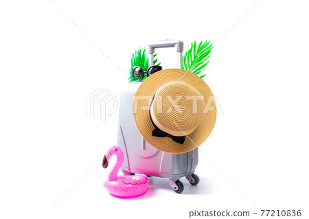 Sea background. Travel accessories with suitcase, straw hat, palm leaves and flamingo in minimal trip vacation concept isolated on white background. Summer vacation and product advertisement concept. Sea background. Travel accessories with suitcase, straw hat, palm leaves and flamingo in minimal trip vacation concept isolated on white background. Summer vacation and product advertisement concept. 77210836