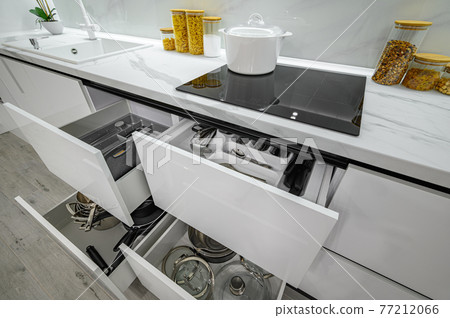 Luxurious white and black modern kitchen interior, drawers pulled out Luxurious white and black modern kitchen interior, drawers pulled out 77212066