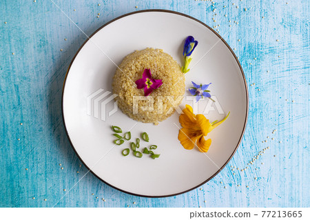 Quinoa plate presentation decorated with edible flowers 77213665