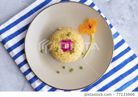 Quinoa plate presentation decorated with edible flowers 77213666