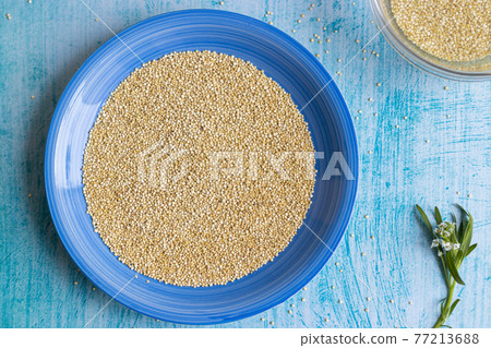 Uncooked quinoa grains inside blue plate Uncooked quinoa grains inside blue plate 77213688