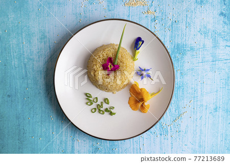 Quinoa plate presentation decorated with edible flowers 77213689