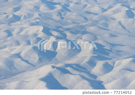Aerial view of snow-capped mountains 77214052