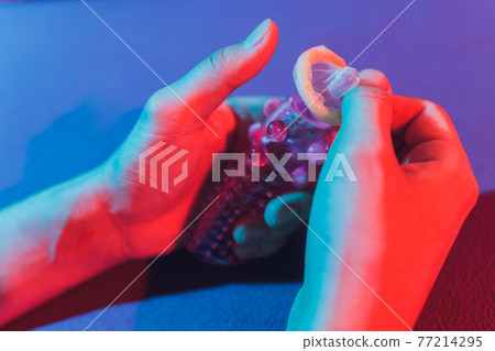 Sex toy - white penis sleeve on red background. 77214295