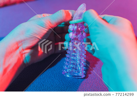 Sex toy - white penis sleeve on red background. 77214299