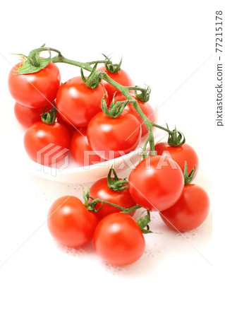 Summer vegetables Fresh cherry tomatoes, tufts, white background Summer vegetables Fresh cherry tomatoes, tufts, white background 77215178