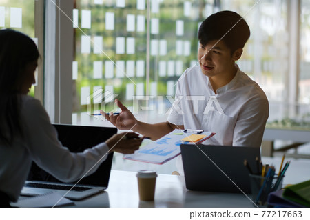 Fund managers team consultation and discuss about analysis Investment stock market by paperwork. 77217663