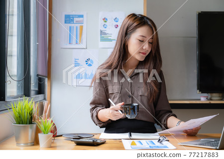 Portrait of business woman and smiling using video call on laptop computer with her parents. Quarantine and work from home concept. Portrait of business woman and smiling using video call on laptop computer with her parents. Quarantine and work from home concept. 77217883