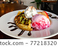 Homemade waffle served with stawberry ice cream and variety fruit. Sweet and crunchy dessert. 77218320