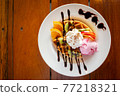 Homemade waffle served with stawberry ice cream and variety fruit. Sweet and crunchy dessert. 77218321