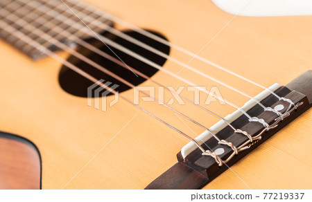 wooden guitar strings closeup 77219337