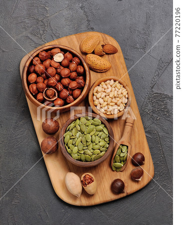 Assorts nuts on board closeup. Assorts nuts on board closeup. 77220196
