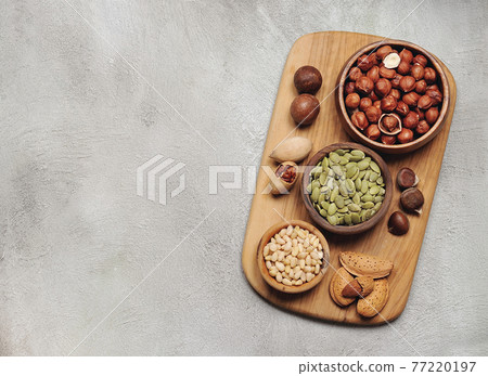 Assorts nuts on board closeup. Assorts nuts on board closeup. 77220197
