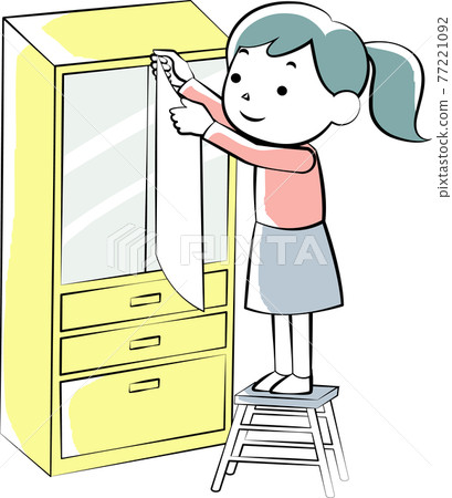 A woman who puts a shatterproof sheet on the cupboard A woman who puts a shatterproof sheet on the cupboard 77221092