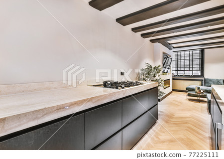 Open plan spacious kitchen with ceiling beams 77225111