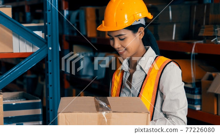 Female warehouse worker working at the storehouse Female warehouse worker working at the storehouse 77226080