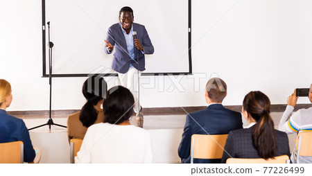Excited african american preacher giving motivational speech Excited african american preacher giving motivational speech 77226499