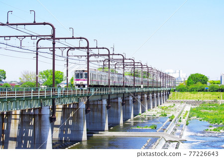 Keio Line 7777 vehicle passing through the Tamagawa Bridge Keio Line 7777 vehicle passing through the Tamagawa Bridge 77226643