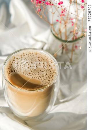 Cup of latte cappuccino. Morning coffee aesthetics vibes. Breakfast. Pink gypsophila flowers 77226703