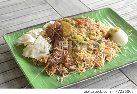 Chicken Briyani rice on table. An Indian cuisine. Chicken Briyani rice on table. An Indian cuisine. 77226865