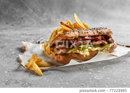 Croissant sandwich with grilled beef tenderloin, sun-dried tomatoes, sauce. Healthy, tasty, nourishing snack. Take away food Croissant sandwich with grilled beef tenderloin, sun-dried tomatoes, sauce. Healthy, tasty, nourishing snack. Take away food 77228985