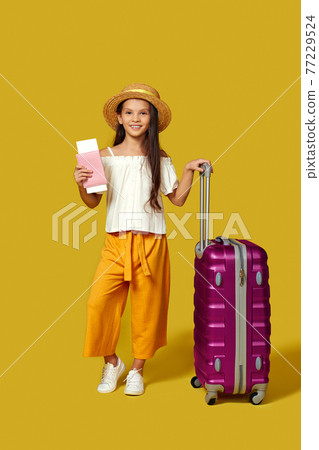 Happy little child girl in hat with pink suitcase 77229524