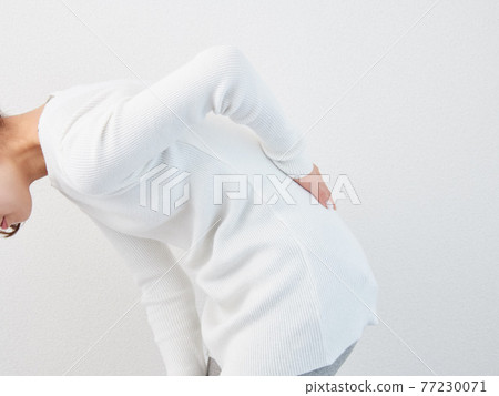 Asian woman suffering from back pain Asian woman suffering from back pain 77230071