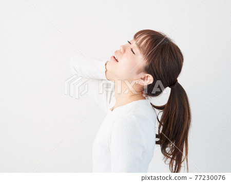 Asian woman with a sore neck Asian woman with a sore neck 77230076