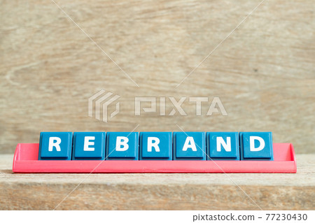 Tile alphabet letter with word rebrand in red color rack on wood background Tile alphabet letter with word rebrand in red color rack on wood background 77230430