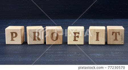 wooden cubes with the inscription profit. Profit making concept, business growth, easy money. wooden cubes with the inscription profit. Profit making concept, business growth, easy money. 77230570