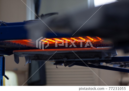 Drying oven for Serigraphy silk screen print process at clothes factory. Drying oven for Serigraphy silk screen print process at clothes factory. 77231055