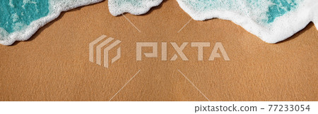 Empty Sand Beach and Soft Blue Wave on Summer Sunny Day. Natural Texture Background. Wide and Long Size for Copy Space. Top View. Focus on Sand Empty Sand Beach and Soft Blue Wave on Summer Sunny Day. Natural Texture Background. Wide and Long Size for Copy Space. Top View. Focus on Sand 77233054