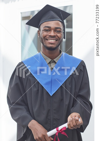 Young man in graduation gown Young man in graduation gown 77233199